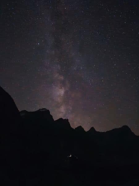 Milky Way galaxy glowing above the mountain peaks at Moraine Lake during a stargazing tour in Banff National Park.