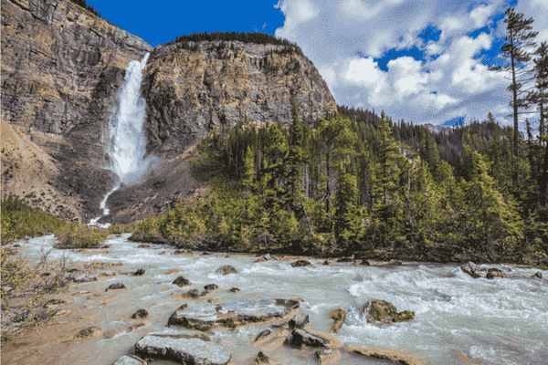 Takakkaw Falls flowing into Yoho Valley with river and forest in Yoho National Park, British Columbia