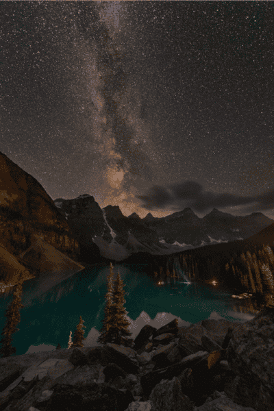 Milky Way galaxy above Moraine Lake with turquoise water and mountain peaks in Banff National Park