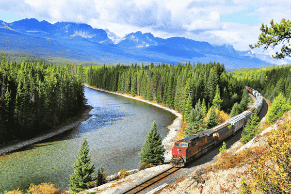 Train rounding Morant’s Curve along the Bow River in Banff National Park, Canadian Rockies